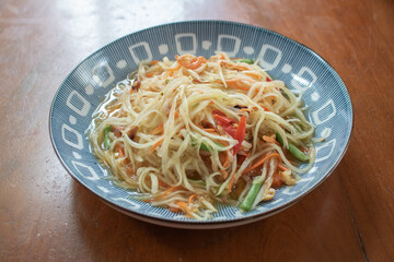 Papaya salad on the wooden table, Thai food.