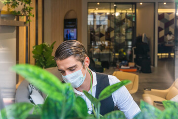 Fototapeta na wymiar businessman with mask to protect coronavirus working in workplace