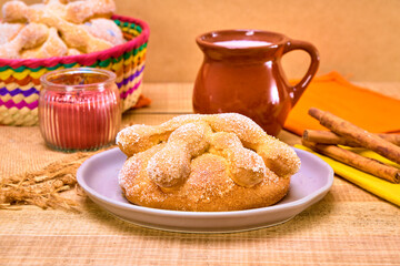 traditional mexican pan de muerto with hot chocolate and cinnamon sticks. Bread to celebrate the...
