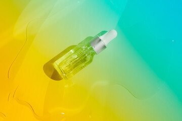 Dropper glass bottles with pipette. Transparent hyaluronic natural beauty mineral product and eco serum skin care concept. Top horizontal view copyspace. Summer juicy colors