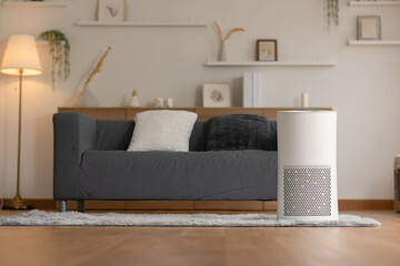 Air purifier in cozy white living room for filter and cleaning removing dust PM2.5 HEPA and virus...