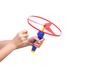 Kid's hands holding and playing toy disc helicopter isolated on white background