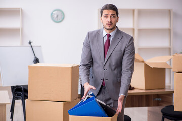 Young male employee in relocation concept