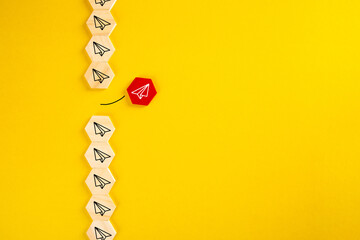 Red wooden blocks with paper plane icons that are different from the group.
