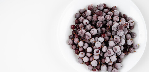 Frozen berries of gooseberry covered with hoarfrost. Close-up.