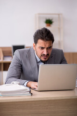 Young male employee working in the office