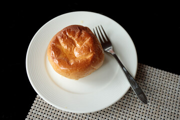 Baked bread topped with oil in a white plate