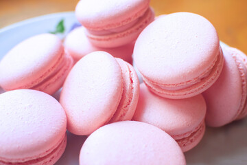 Sweet, tender and bright raspberries macarons on a white plate. French dessert.