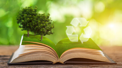 Energy sources for renewable, sustainable development. Ecology concept. A book that opens in the middle with a tree and a recycling sign.