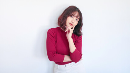 Thinking gesture of Asian beautiful girl with red shirt in white background