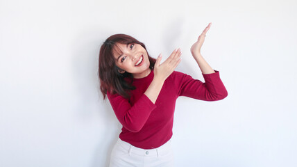 Fototapeta na wymiar happy pointing above of Asian beautiful girl with red shirt in white background