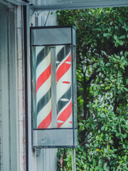 Barber shop pole at barber shop for open and close sign.