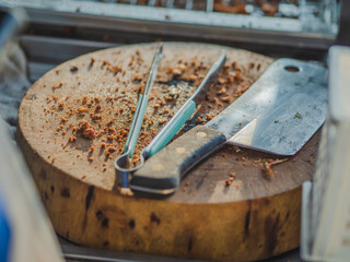 Fried chicken on chopping board and knife,tong  at street food shop so delicious food.
