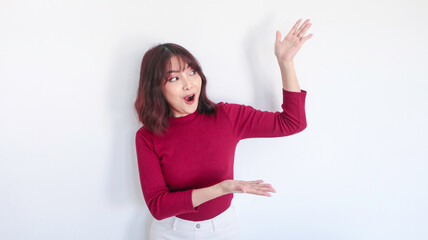 Shock Asian beautiful girl point beside her with red shirt in white background