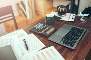 Accounting woking with data sheet on the office desk. Calculator with accounting report and financial statement on desk.