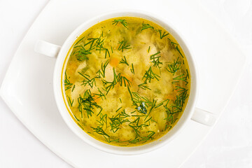 egetable broth with carrots, potatoes and cabbage, peas and bread. Healthy food for children.