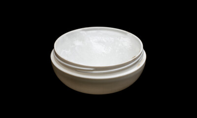 Used white plastic cream container on isolated black background