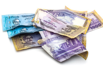 A bunch of scattered and wrapped one thousand taka bangladesh banknotes on white background