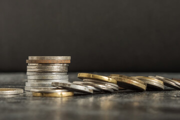 Close-up of various coins stacked on top of each other on a black background
