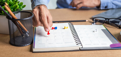 Businessman agenda calendar and reminder agenda work online at home men plan daily appointments and vacation travel journals in a diary at their desk . calendar reminder event concept .