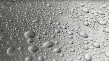 Fototapeta na wymiar Close-up of water droplets on silver glass.