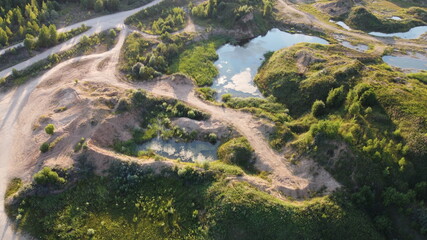 Flooded and overgrown sand quarry. Lush green summer landscape for outdoors vacation, hiking, camping or tourism. Volokolamsk district of Moscow region. Sychevo beach, Russia