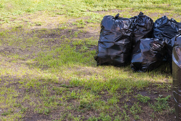 Garbage full black bags are ready to be sent for waste disposal.