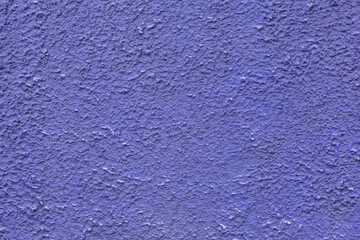 The wall is finished with relief decorative plaster. Abstract background, texture.