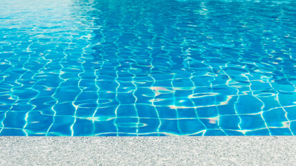 Poolside in the resort. Swimming pool background. Sunshine and clear water. Hotel accommodation.