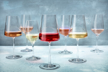 Rose and white wine in a variety of color in elegant glasses at a tasting at a winery. Winetasting event