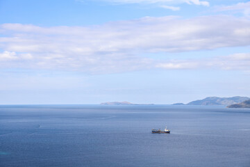 Fototapeta na wymiar Sea background with Fishing boat sailing under blue sky