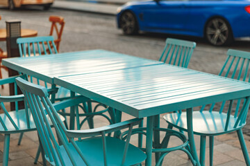 Empty table and chairs of street cafe