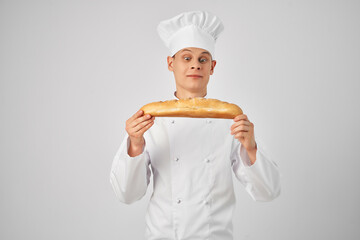 male chef with a baguette in his hands fresh product professional work