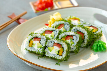 Vegeterian sushi roll with dill and vegetables on wooden background