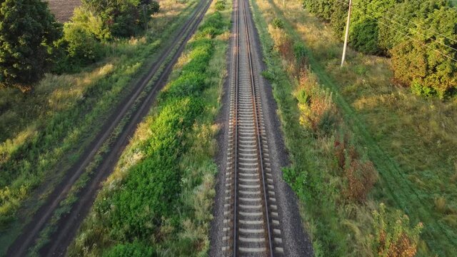 Railroad tracks top view. Flight over the road with rails