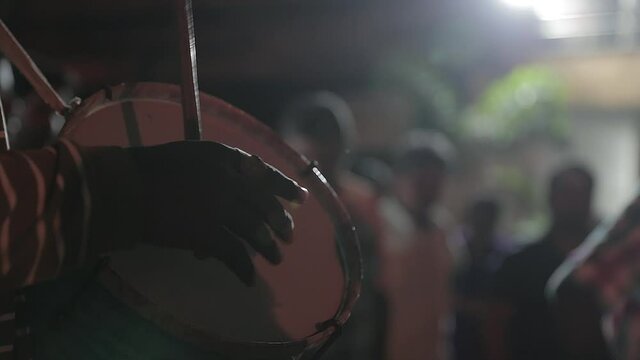 Gimbal close up shot of percussionist hands playing typical Indian drum in party at night