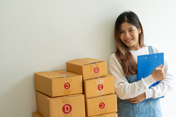 SME business online and delivery concept, freelance woman working at home with Online Parcel delivery.