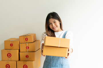 SME business online and delivery concept, freelance woman working at home with Online Parcel delivery.
