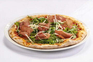 Italian pizza with prosciutto and ruccola