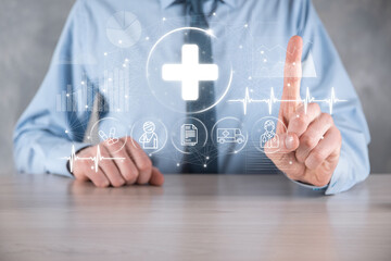 Businessman hold virtual plus medical network connection icons. Covid-19 pandemic develop people awareness and spread attention on their healthcare.Doctor,document,medicine,ambulance,patient icon.