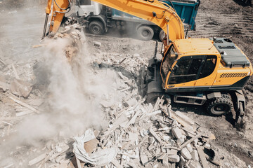 Demolition of old house building process for new construction by excavator bucket, aerial view....