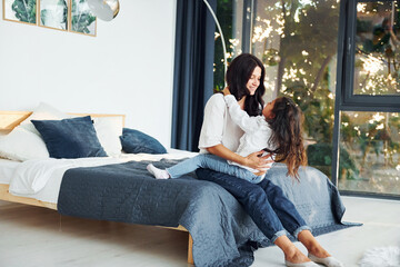 Love of child and parent. Mother and her daughter spending time together at home