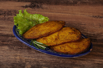 Baked potato with herbs and spices