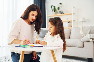 Happy family. Mother and her daughter spending time together at home