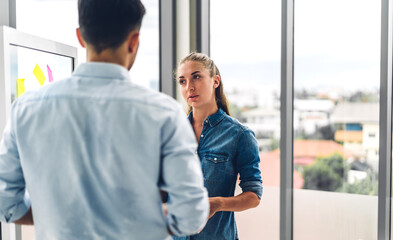 Obraz premium Two professional business man and woman meeting and discussing strategy with new startup project.Creative business people planning and brainstorm in modern office.Teamwork