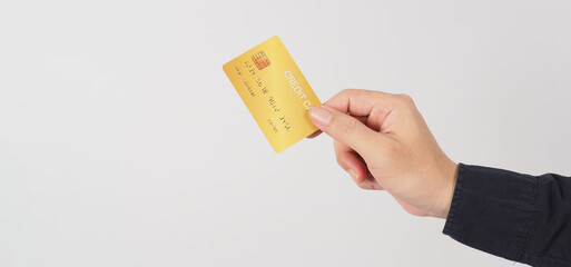 Hand is holding gold credit card isolated on white background. Asian man hand.