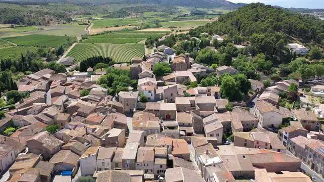 Scenic aerial view of French township of Fontcouverte at foot of Alaric mountain on sunny summer day, Aude, Occitanie