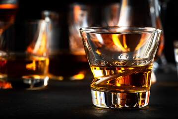 Strong alcoholic drinks, spirits and distillates iset in glasses: cognac, scotch, whiskey and...