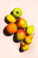 Summer fruits top view. Contemporary still life, lime green background, hard light and shadow