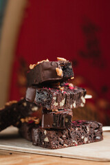 many delicious chocolate brownies with nuts in chocolate on a stick in the summer in a cafe